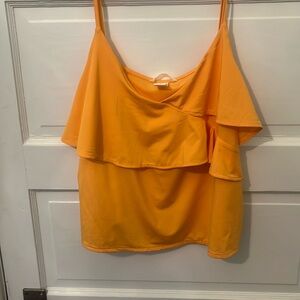 Faux wrap v-neck float tank. Adjustable straps. Loose ruffles on chest. Size M.